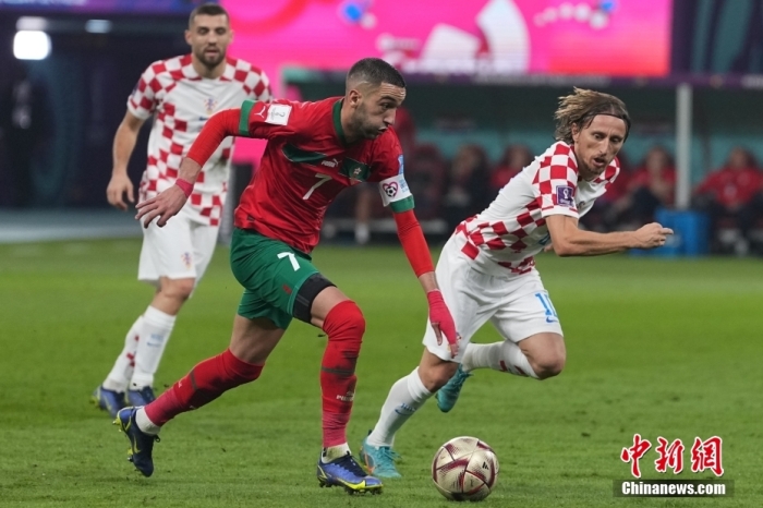 北京时间12月17日晚23点，2022卡塔尔世界杯季军赛在哈利法体育场打响，克罗地亚队迎战摩洛哥队。图为摩洛哥队球员(红)带球。中新社记者 崔楠 摄